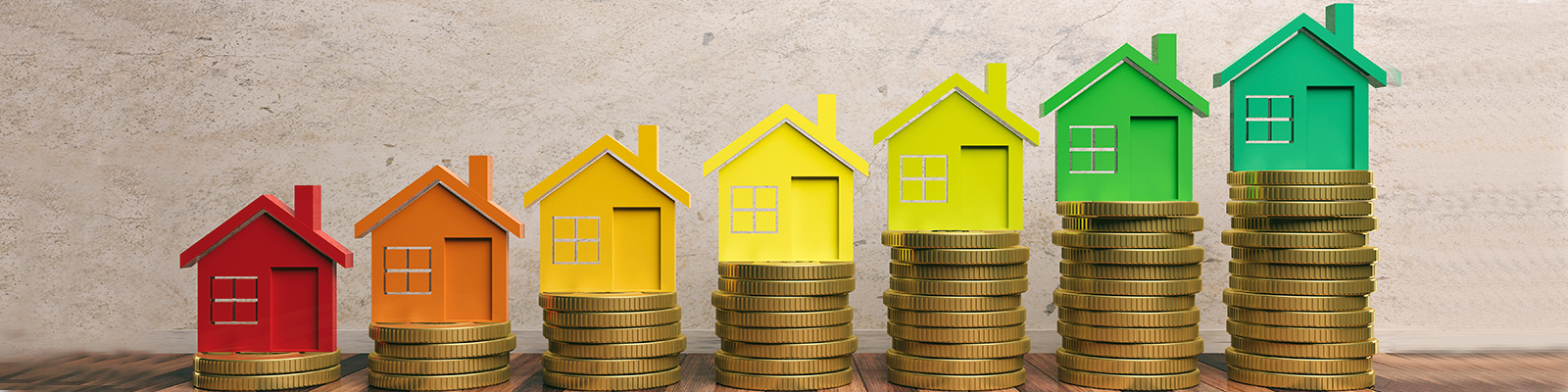 colorful houses stacked on top of coins
